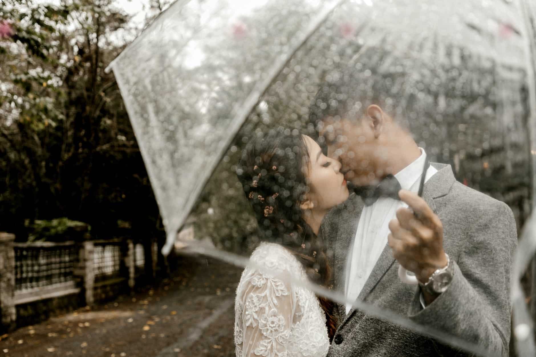 couple kissing under umbrella